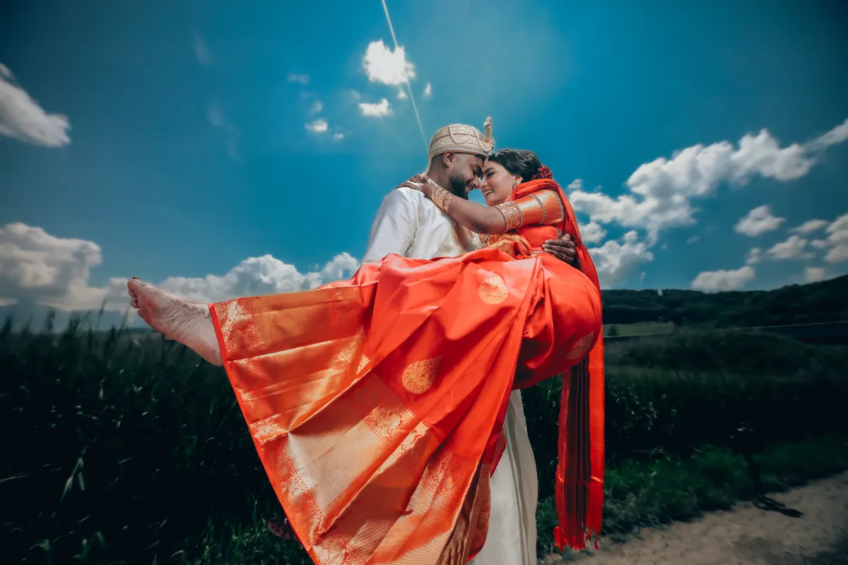 A couple embracing under a bright blue sky