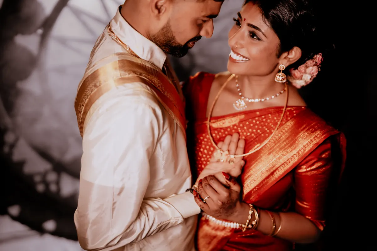 A couple laughing together in their wedding clothes